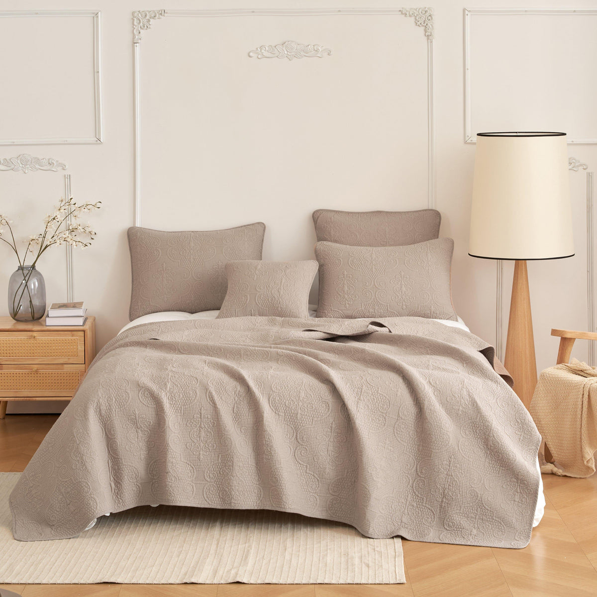 Taupe matelasse cotton bedspread on a made bed