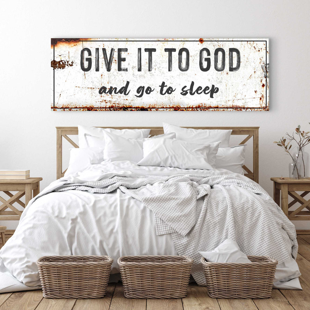 Give It to God and Go to Sleep sign above a white bed