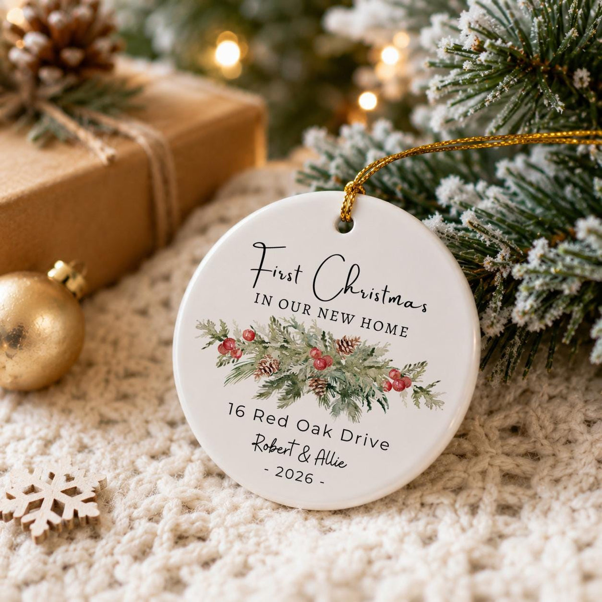 Personalized first Christmas in our new home ceramic ornament hanging on a snowy tree